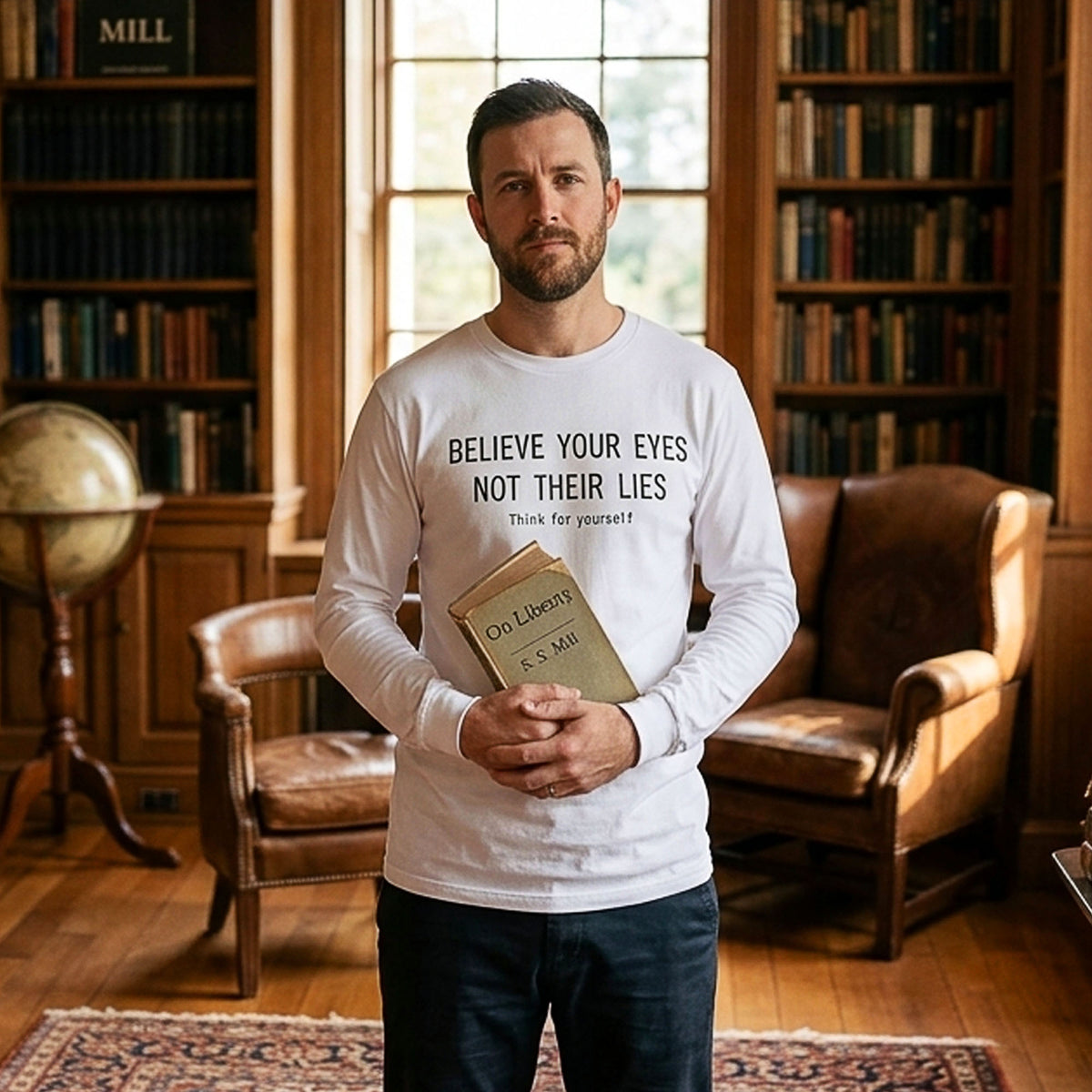 Person holding books in a library while wearing a white long-sleeve t-shirt with black text ‘BELIEVE YOUR EYES,’ ‘NOT THEIR LIES,’ and ‘Think for yourself.