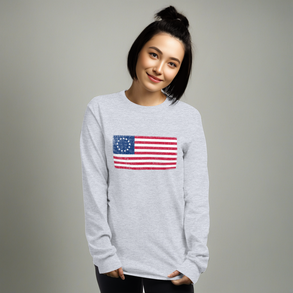 Person wearing sport grey long sleeve t-shirt with a distressed image of the Betsy Ross Flag.