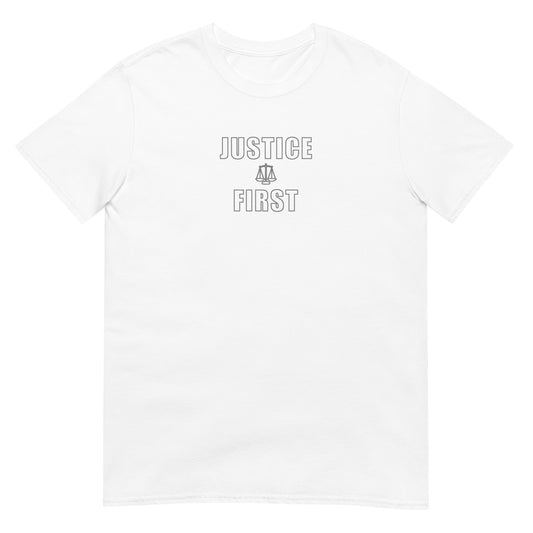 White t-shirt with the words in outlined block letters "Justice First" with a line drawing of the scales of justice between the words in silver ink
