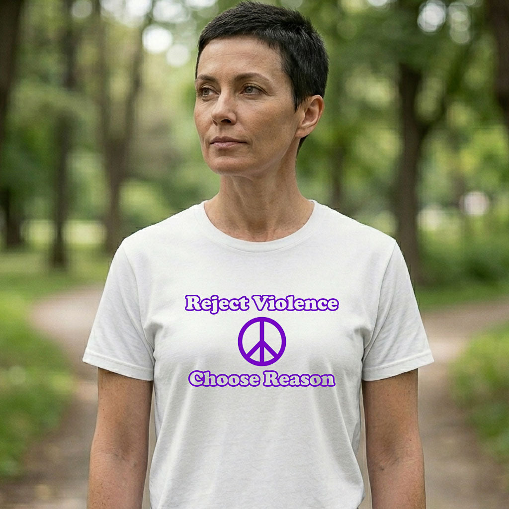 Person wearing a white t-shirt with 'Reject Violence, Choose Reason' text and peace symbol in a park setting
