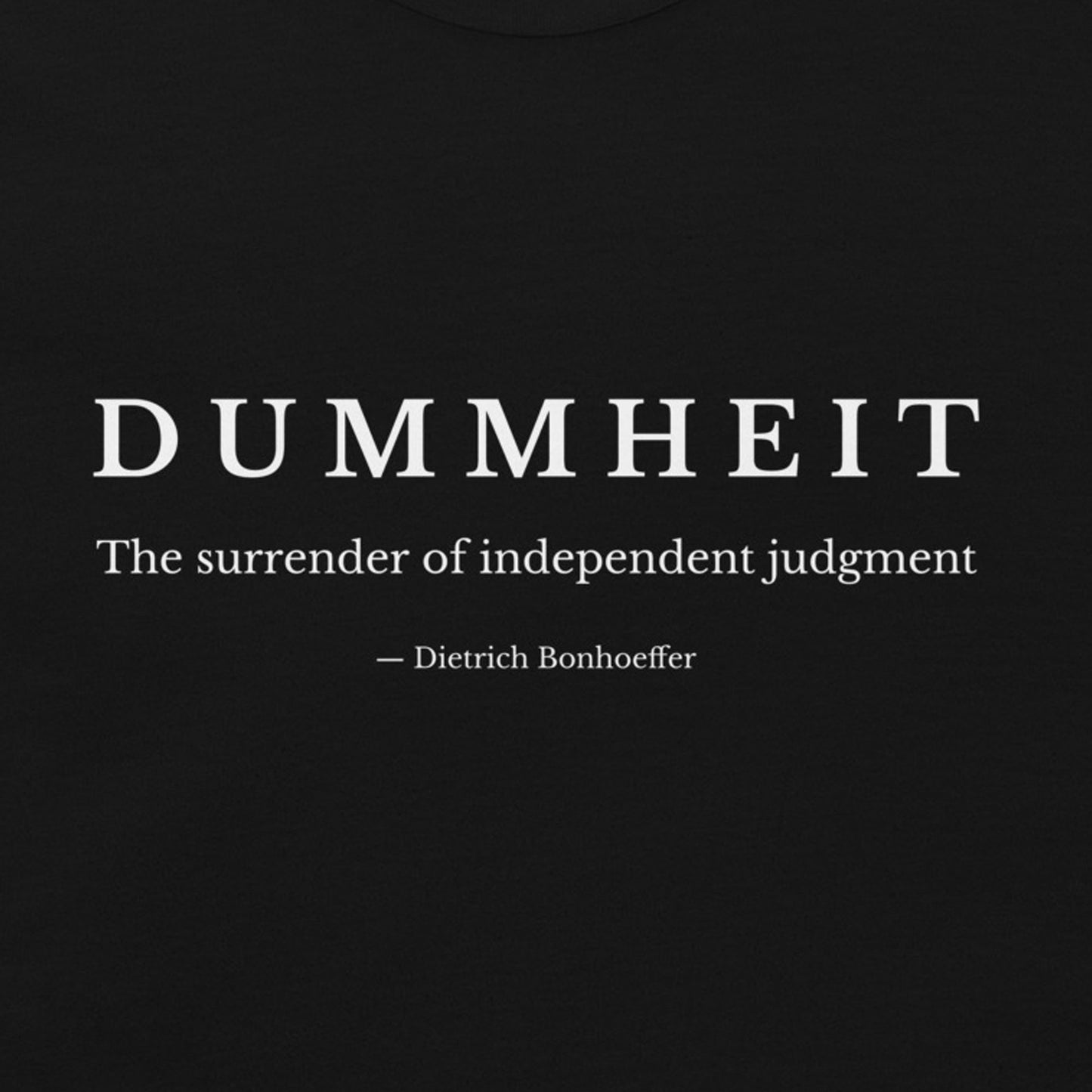 black shirt with minimalist typography reading “Dummheit – The surrender of independent judgment,” inspired by Dietrich Bonhoeffer’s philosophy on independent judgment. zoom design