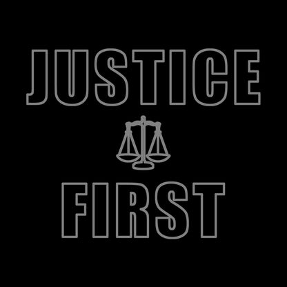 Text outlined block letters "Justice First" with a line drawing of the scales of justice between the words in silver ink on black background