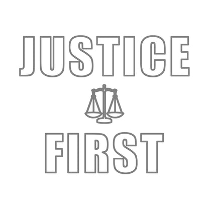Text outlined block letters "Justice First" with a line drawing of the scales of justice between the words in silver ink on white background