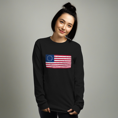 Person wearing black long sleeve -shirt with a distressed image of the Betsy Ross Flag.