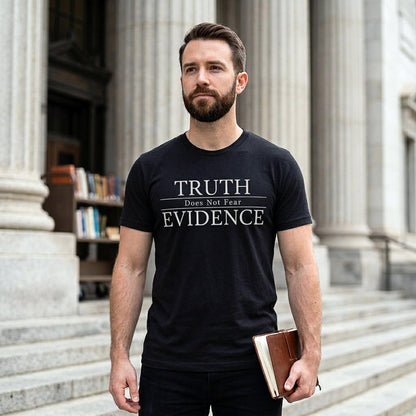 Man wearing a black t-shirt with 'TRUTH Does Not Fear EVIDENCE' text, standing in front of classical architecture.