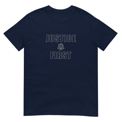 Navy blue t-shirt with text outlined block letters "Justice First" with a line drawing of the scales of justice between the words in silver ink.