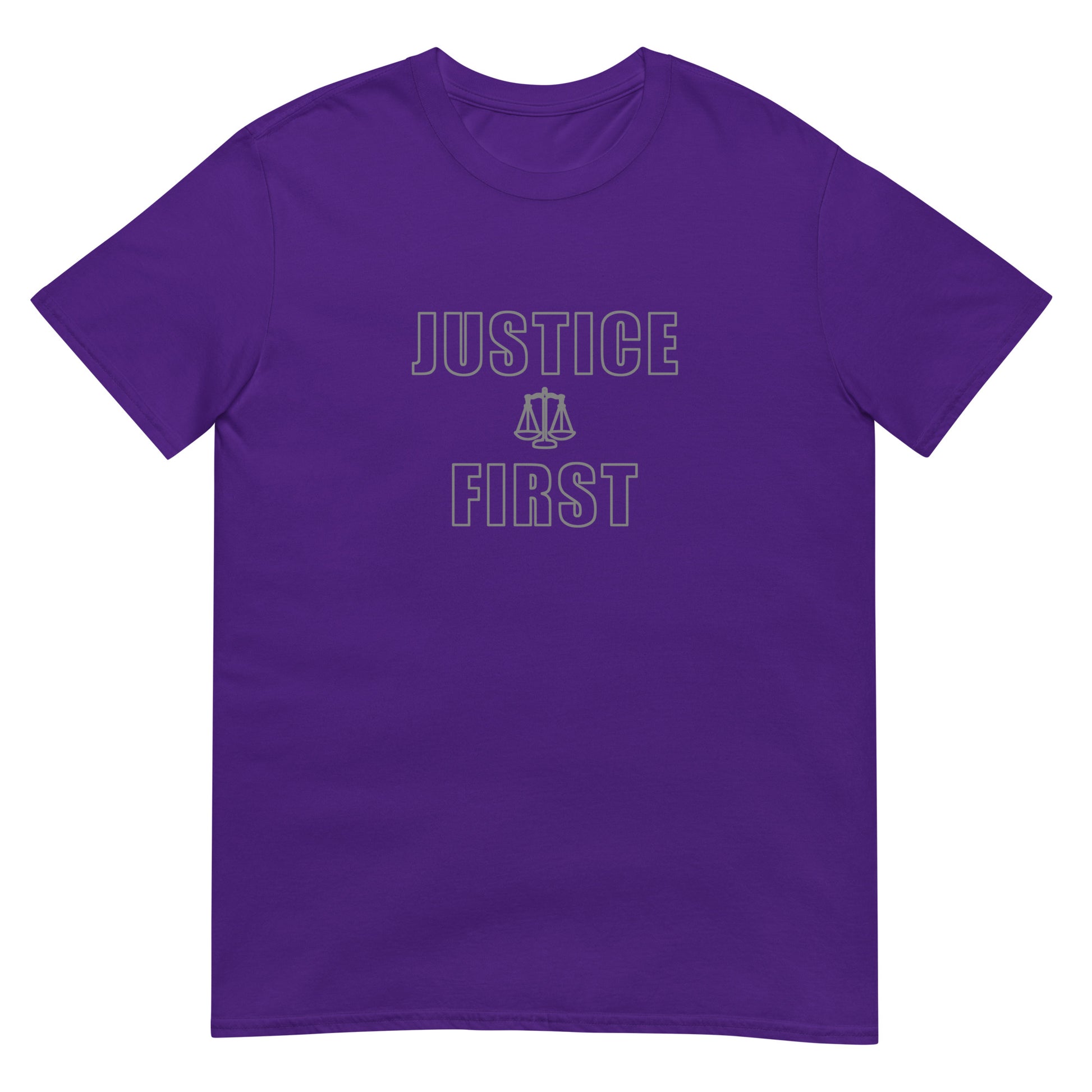 Purple t-shirt with text outlined block letters "Justice First" with a line drawing of the scales of justice between the words in silver ink.