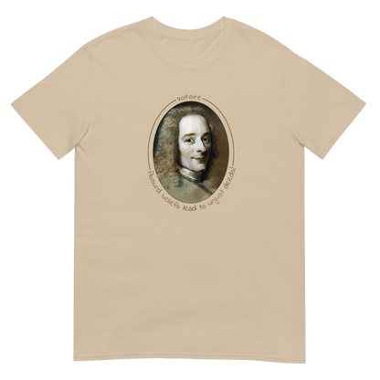 A Sand color short-sleeve unisex t-shirt with a portrait of Voltaire in a circular frame on the front. Text 'Absurd beliefs lead to unjust deeds' in gold ink
