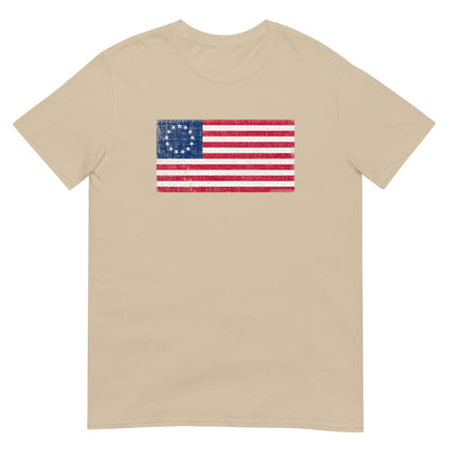 Sand unisex t-shirt with a distressed  image of a Betsy Ross Flag with 13 stars.