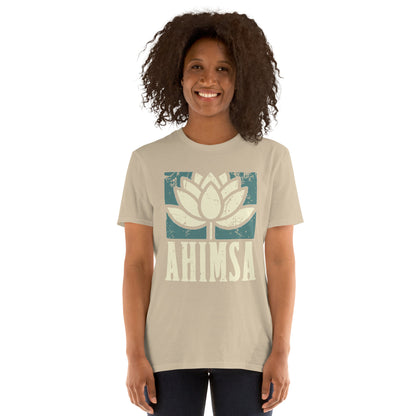 Person wearing a sand  t-shirt with a distress image of a lotus flower and the text "AHIMSA"