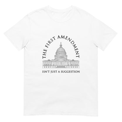 White t-shirt with the text "The First Amendment" in an arch over a line drawing of the US Capitol. A line of text across the bottom of the design "Isn't Just A Suggestion"