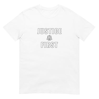 White t-shirt with text outlined block letters "Justice First" with a line drawing of the scales of justice between the words in silver ink.
