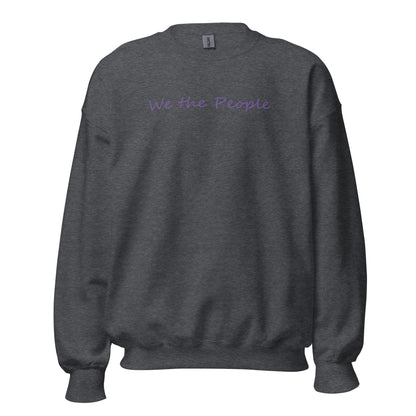 Dark heather unisex crew neck sweatshirt with the words "We the People" in a script font using purple ink.
